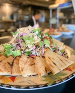 Tree Hugger Bowl with mixed greens quinoa avocado hummus almonds and pita at Manoli’s Pizza Company in Kihei Maui